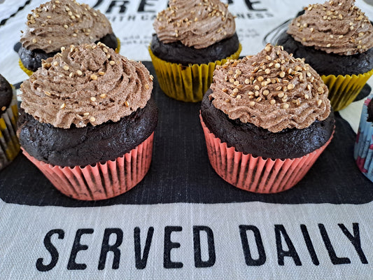 A couple of vegan chocolate muffins with creamy frosting